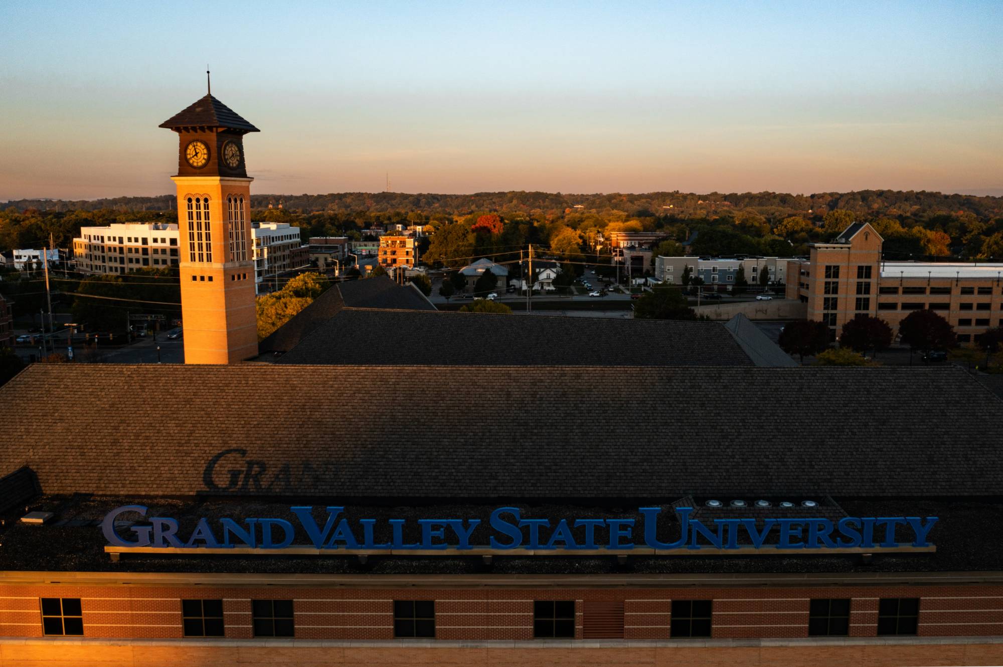 Drone view of the DeVos Center with the Grand Valley State University sign and the Carillon Tower on the Pew Campus